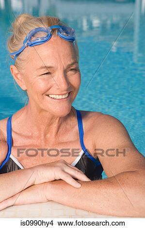 Picture - Mature woman in swimming pool. Fotosearch
