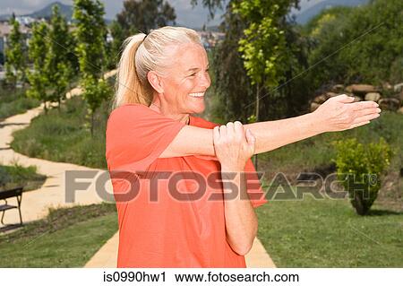 Mature woman runner stretching arm View Large Photo Image Stock Image - Mature woman runner stretching arm. Fotosearch