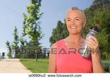 Mature woman runner with water bottle View Large Photo Image Stock Image - Mature woman runner with water bottle. Fotosearch