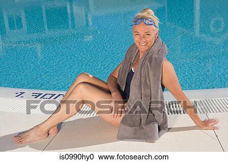 Mature woman sitting by swimming pool View Large Photo Image Stock Image - Mature woman sitting by swimming pool. Fotosearch