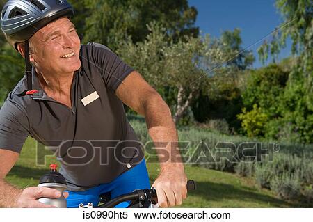 Stock Photography - Senior male cyclist wearing helmet. Fotosearch