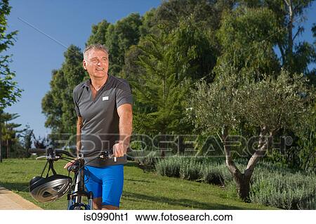 Senior male cyclist with bicycle View Large Photo Image Stock Image - Senior male cyclist with bicycle. Fotosearch