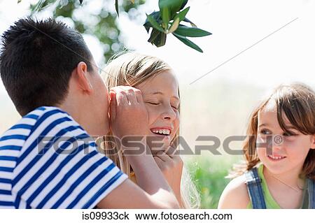 Boy whispering to firiend View Large Photo Image Stock Image - Boy whispering to firiend. Fotosearch
