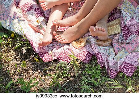 Children lying barefoot on patchwork blanket, low section View Large Photo Image Stock Image - Children lying barefoot on patchwork blanket, low section. Fotosearch