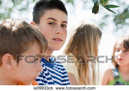 Four friends, older boy looking at camera View Large Photo Image Stock Image - Four friends, older boy looking at camera. Fotosearch