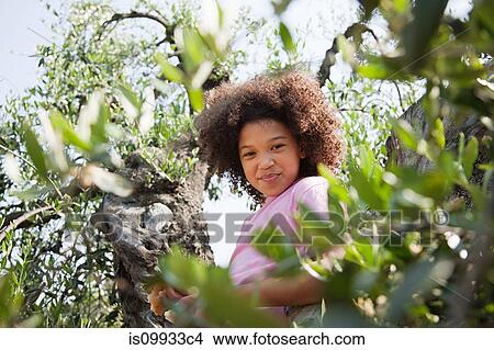 Picture - Girl climbing tree. Fotosearch