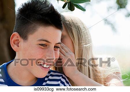Girl whispering to firiend View Large Photo Image Stock Image - Girl whispering to firiend. Fotosearch