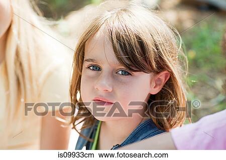 Picture - Pensive girl looking at camera, portrait. Fotosearch