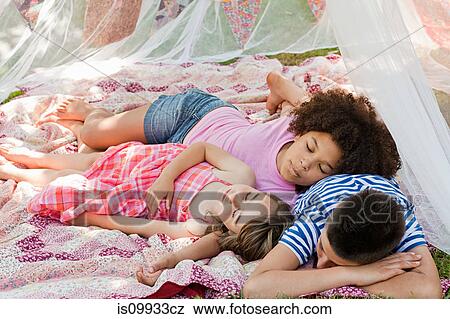 Three friends sleeping in summer netting tent View Large Photo Image Stock Photo - Three friends sleeping in summer netting tent. Fotosearch