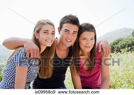 Stock Photo - Three young friends looking at camera. Fotosearch
