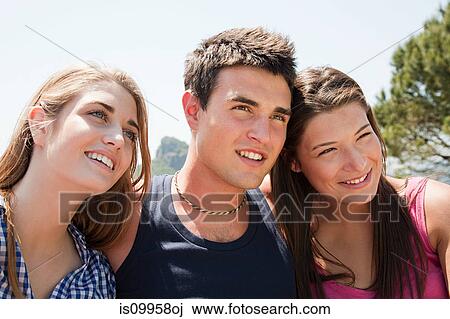 Stock Image - Three young friends looking away. Fotosearch