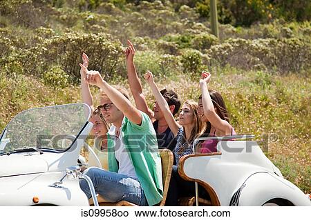 Picture - Young friends in convertible car. Fotosearch