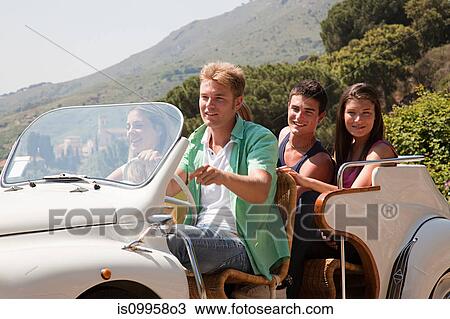 Young friends in convertible car View Large Photo Image Stock Image - Young friends in convertible car. Fotosearch