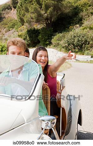 Young people driving convertible car View Large Photo Image Stock Image - Young people driving convertible car. Fotosearch