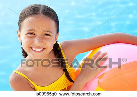 Girl with beach ball by swimming pool, portrait View Large Photo Image Stock Image - Girl with beach ball by swimming pool, portrait. Fotosearch