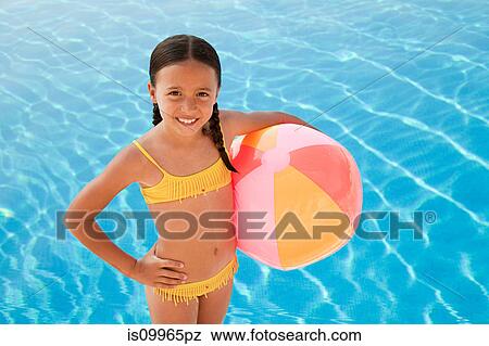 Girl with beach ball by swimming pool, portrait View Large Photo Image Stock Photo - Girl with beach ball by swimming pool, portrait. Fotosearch
