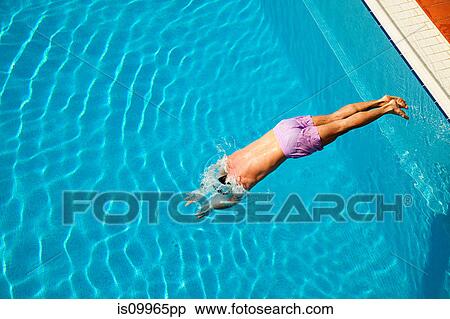 Stock Photography - Young man diving into swimming pool. Fotosearch
