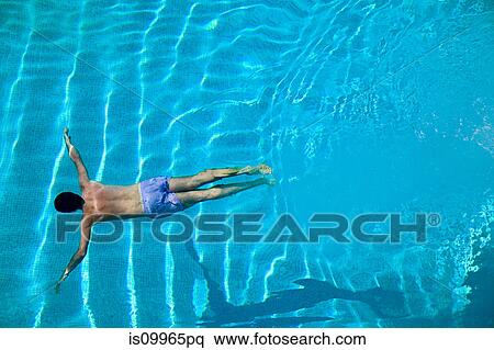 Young man diving into swimming pool View Large Photo Image Stock Photography - Young man diving into swimming pool. Fotosearch