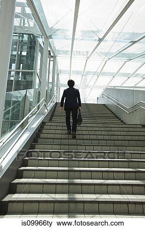 Stock Photo - Businessman going up steps. Fotosearch