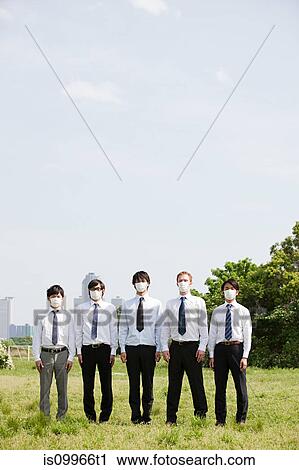 Businessmen in a row wearing pollution masks View Large Photo Image Stock Image - Businessmen in a row wearing pollution masks. Fotosearch