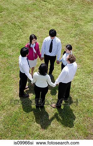 Businesspeople in a circle in field, high angle View Large Photo Image Stock Image - Businesspeople in a circle in field, high angle. Fotosearch