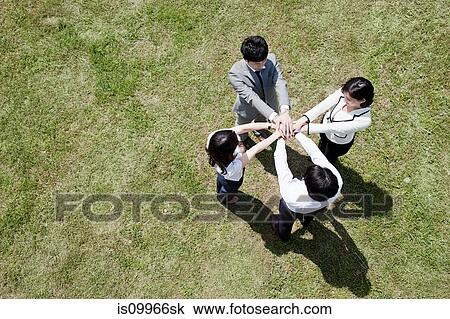 Businesspeople in a circle in field, high angle View Large Photo Image Stock Image - Businesspeople in a circle in field, high angle. Fotosearch