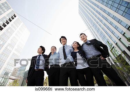 Businesspeople in a row in city scene View Large Photo Image Stock Image - Businesspeople in a row in city scene. Fotosearch