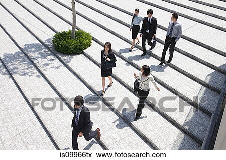 Stock Photo - Businesspeople on steps, high angle. Fotosearch