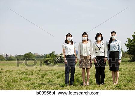 Businesswoman wearing pollution masks in field View Large Photo Image Picture - Businesswoman wearing pollution masks in field. Fotosearch