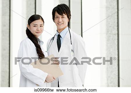 Stock Photo - Male and female doctors, portrait. Fotosearch