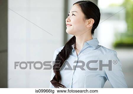 Portrait of young businesswoman looking away View Large Photo Image Stock Image - Portrait of young businesswoman looking away. Fotosearch