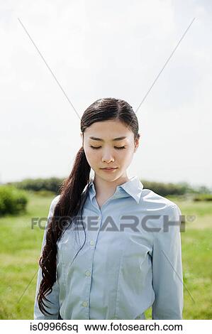 Stock Photography - Portrait of young businesswoman with eyes closed. Fotosearch