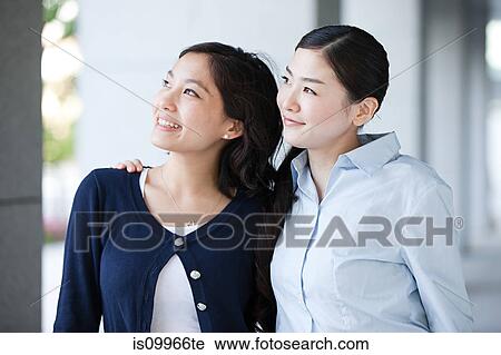 Two businesswomen looking away View Large Photo Image Stock Image - Two businesswomen looking away. Fotosearch