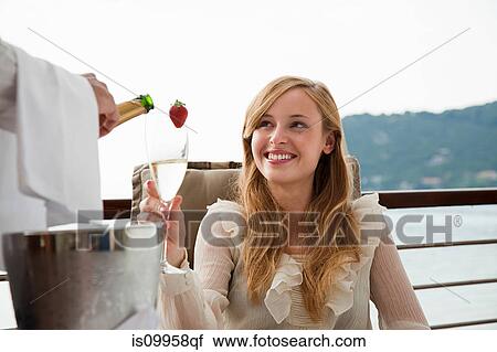Waiter pouring woman champagne View Large Photo Image Stock Image - Waiter pouring woman champagne. Fotosearch