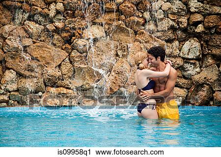 Stock Image - Young couple in swimming pool. Fotosearch