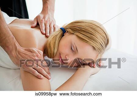 Young woman being massaged View Large Photo Image Stock Photo - Young woman being massaged. Fotosearch