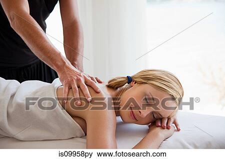 Stock Photo - Young woman being massaged. Fotosearch