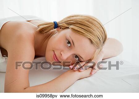 Young woman lying on massage table View Large Photo Image Stock Photo - Young woman lying on massage table. Fotosearch