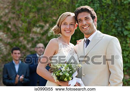 Newlyweds at marriage ceremony, looking away View Large Photo Image Stock Photography - Newlyweds at marriage ceremony, looking away. Fotosearch
