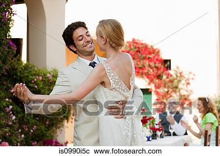 Stock Image - Newlyweds dancing at wedding reception. Fotosearch