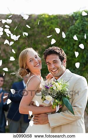 Newlyweds embracing at marriage ceremony View Large Photo Image Stock Photo - Newlyweds embracing at marriage ceremony. Fotosearch
