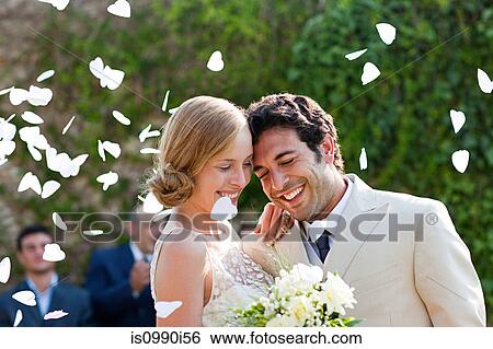 Newlyweds embracing at marriage ceremony View Large Photo Image Stock Photograph - Newlyweds embracing at marriage ceremony. Fotosearch