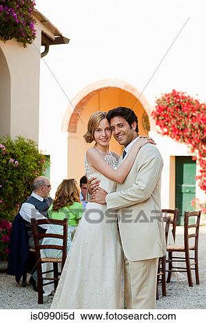 Newlyweds embracing at wedding reception View Large Photo Image Stock Image - Newlyweds embracing at wedding reception. Fotosearch