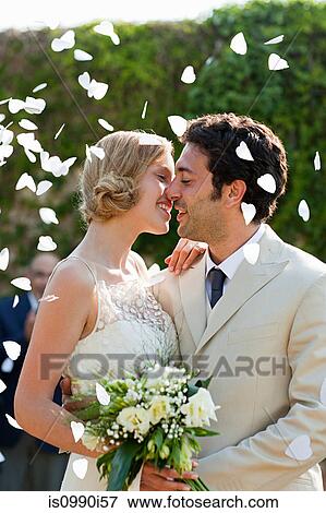 Stock Photo - Newlyweds kissing at marriage ceremony. Fotosearch