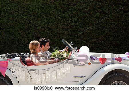 Newlyweds leaving for honeymoon in vintage car View Large Photo Image Stock Image - Newlyweds leaving for honeymoon in vintage car. Fotosearch
