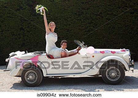 Newlyweds leaving for honeymoon in vintage car View Large Photo Image Stock Photo - Newlyweds leaving for honeymoon in vintage car. Fotosearch