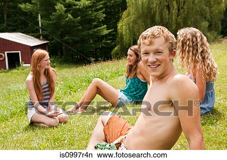 Friends relaxing together on a lawn in summer View Large Photo Image Picture - Friends relaxing together on a lawn in summer. Fotosearch