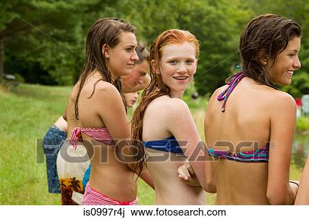 Girls in bikinis watching friends playing around in the country View Large Photo Image Stock Image - Girls in bikinis watching friends playing around in the country. Fotosearch