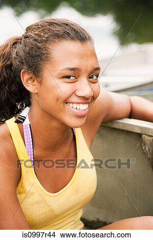 Picture - Teenage girl in a rowing boat on a lake. Fotosearch