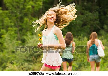 Teenage girl turning around and flicking hair View Large Photo Image Stock Image - Teenage girl turning around and flicking hair. Fotosearch